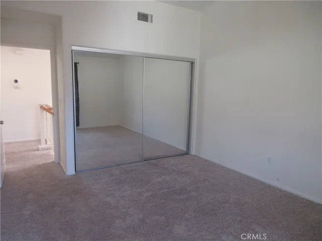 an empty room with closet area