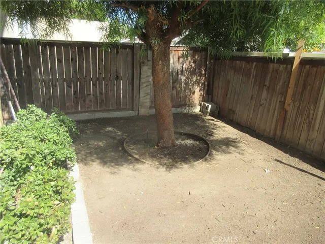 a view of a backyard with wooden fence