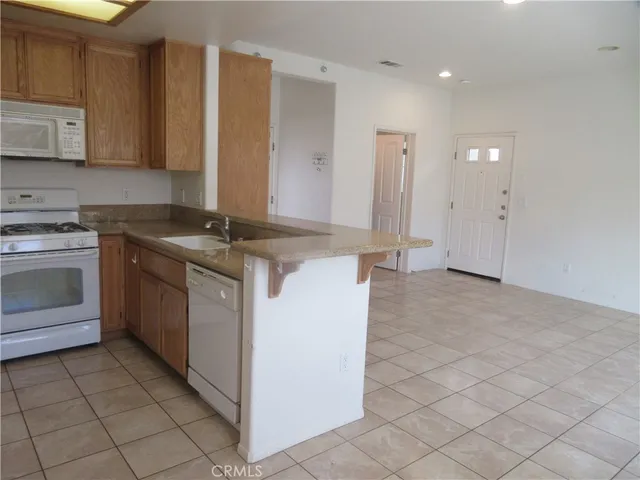 a kitchen with a stove sink and cabinets