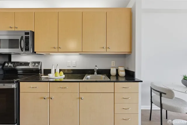 a kitchen with sink and cabinets