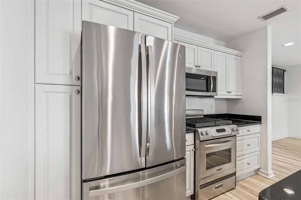 1685 Laurel Street, Unit 3 Sarasota, FL 34236 - Photo 11 of 54 a kitchen with stainless steel appliances a refrigerator stove and microwave