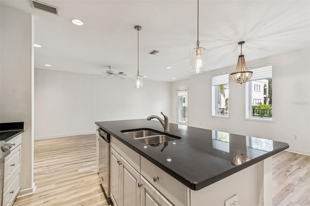 1685 Laurel Street, Unit 3 Sarasota, FL 34236 - Photo 12 of 54 a kitchen with granite countertop a sink a counter top space and stainless steel appliances