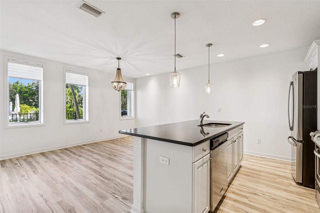 1685 Laurel Street, Unit 3 Sarasota, FL 34236 - Photo 13 of 54 a kitchen with kitchen island granite countertop stainless steel appliances lots of counter space wooden floor and window