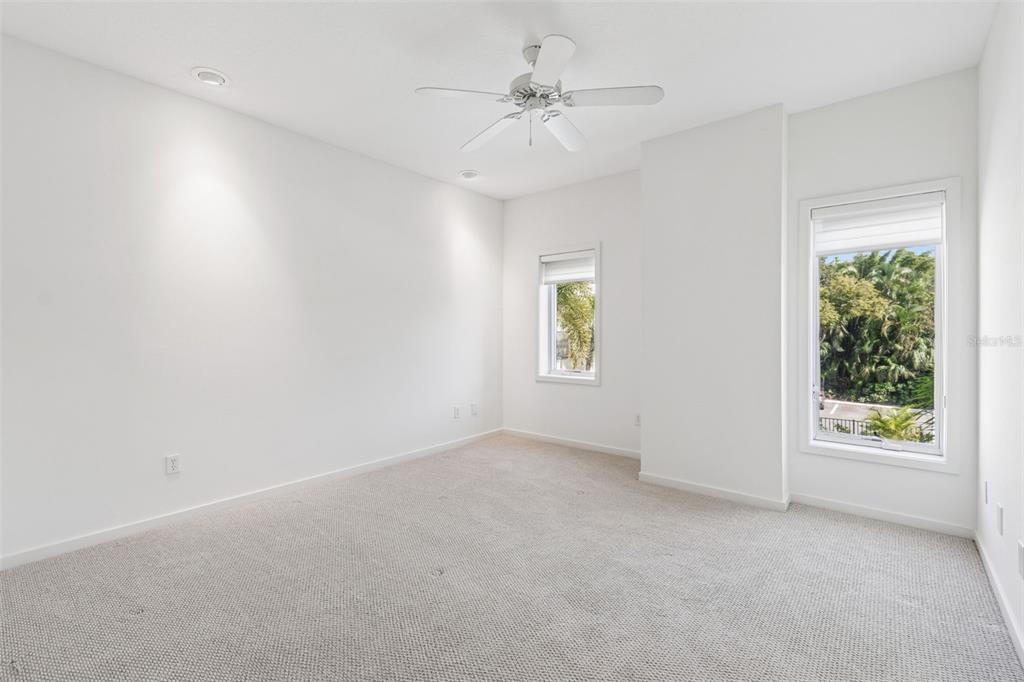 1685 Laurel Street, Unit 3 Sarasota, FL 34236 - Photo 24 of 54 an empty room with windows and ceiling fan