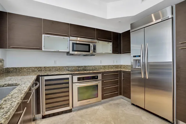 a kitchen with granite countertop stainless steel appliances and counter space