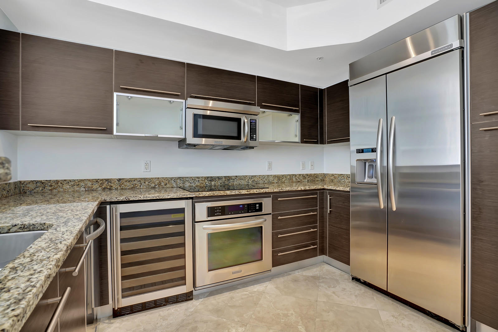 a kitchen with granite countertop stainless steel appliances and counter space