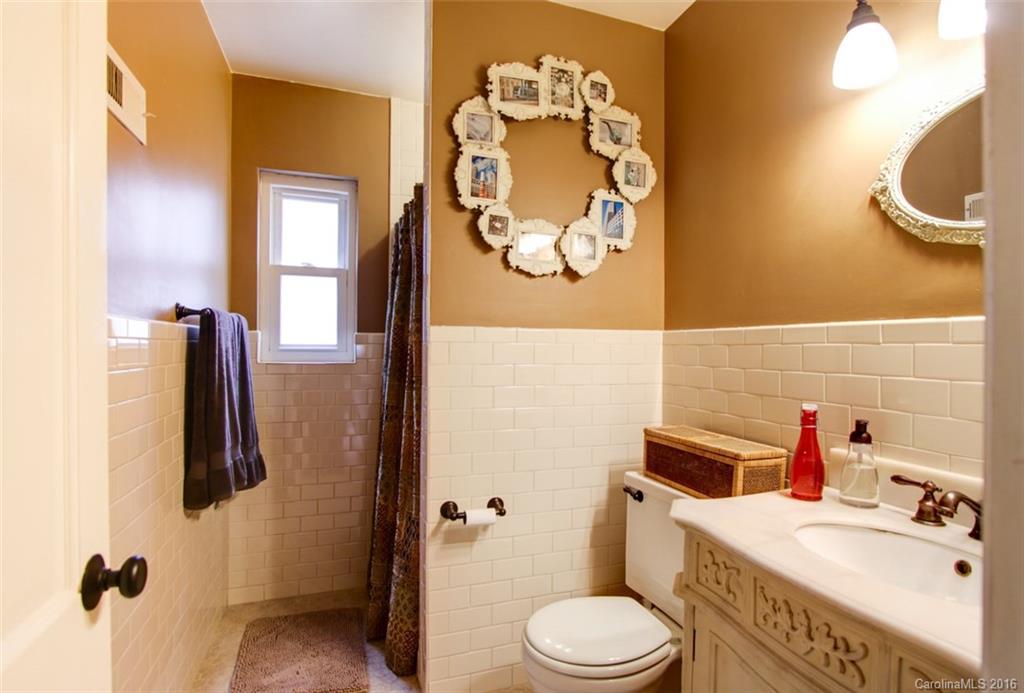1400 Ferncliff Road Charlotte, NC 28211 - Photo 14 of 21 a bathroom with a sink mirror vanity and toilet