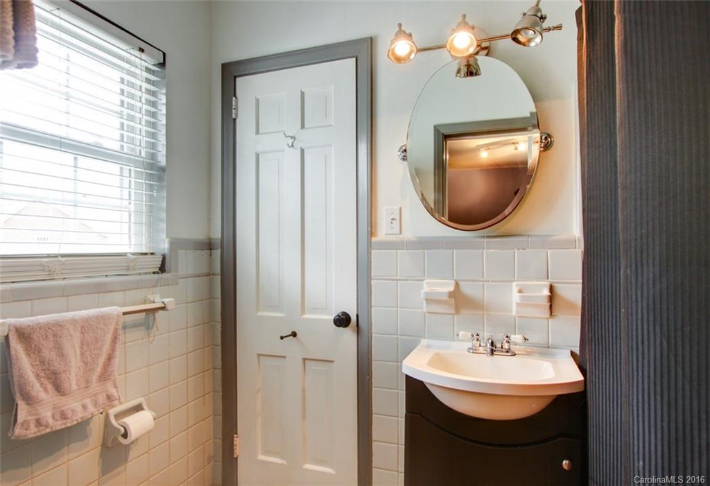 1400 Ferncliff Road Charlotte, NC 28211 - Photo 17 of 21 a bathroom with a sink a mirror and a toilet