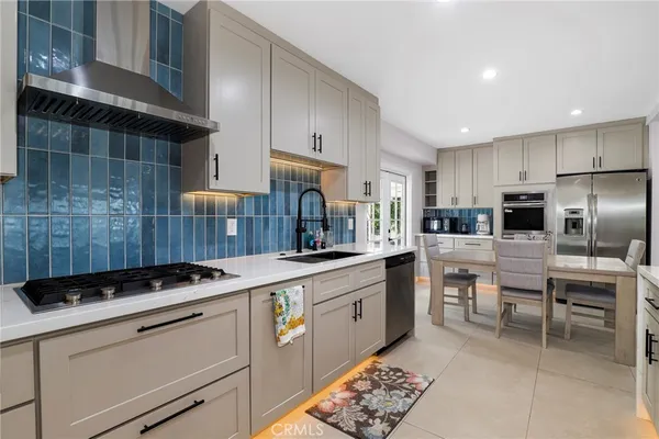 a kitchen with a sink stainless steel appliances and cabinets