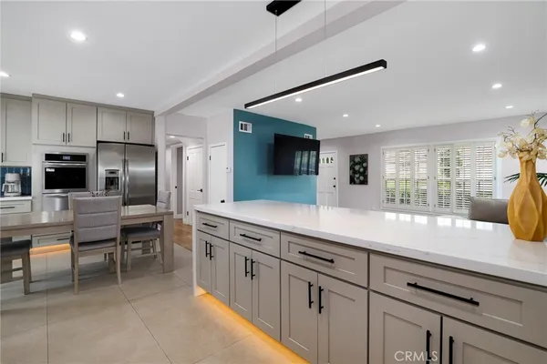 a kitchen with kitchen island granite countertop a sink stainless steel appliances and cabinets