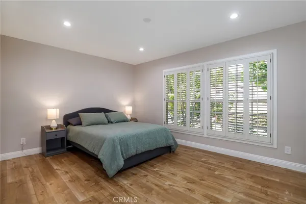 a bedroom with a large bed and a large window