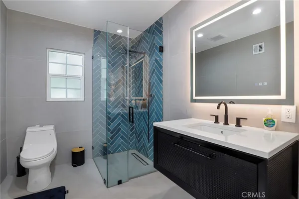 a bathroom with a sink toilet and shower