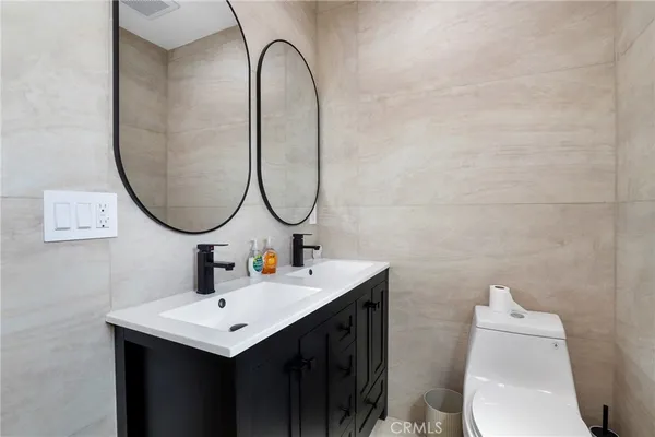 a bathroom with a sink mirror and toilet