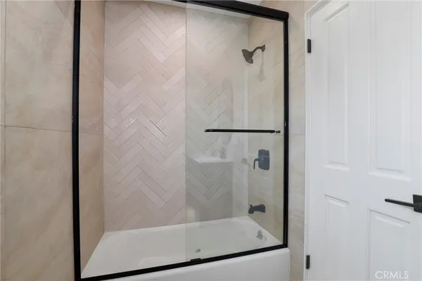 a bathroom with a glass shower door