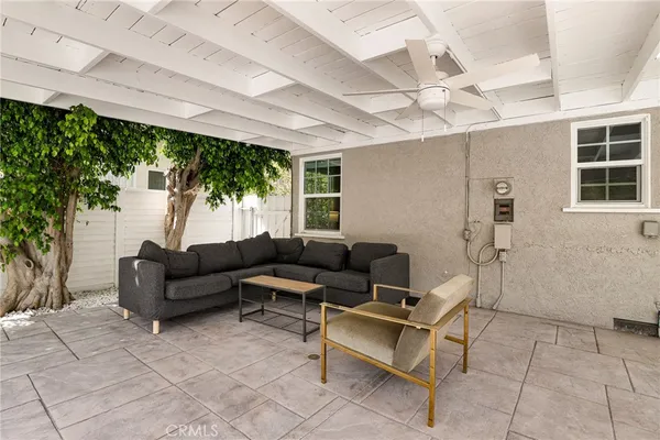 a living room with furniture a ceiling fan and a window