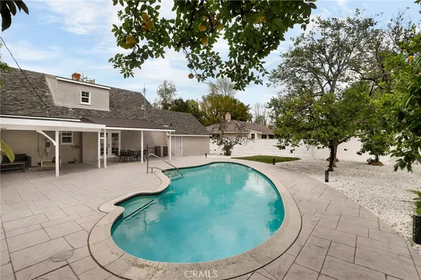 a view of a swimming pool with outdoor seating