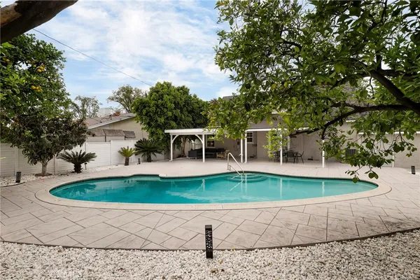 a view of a swimming pool with a yard