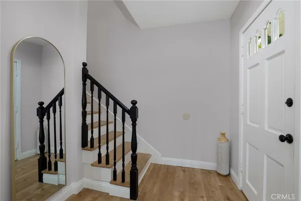 a view of an entryway with wooden floor