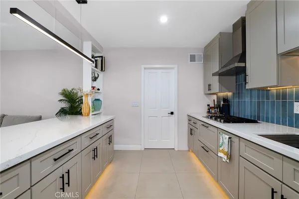 a kitchen with stainless steel appliances a sink and cabinets