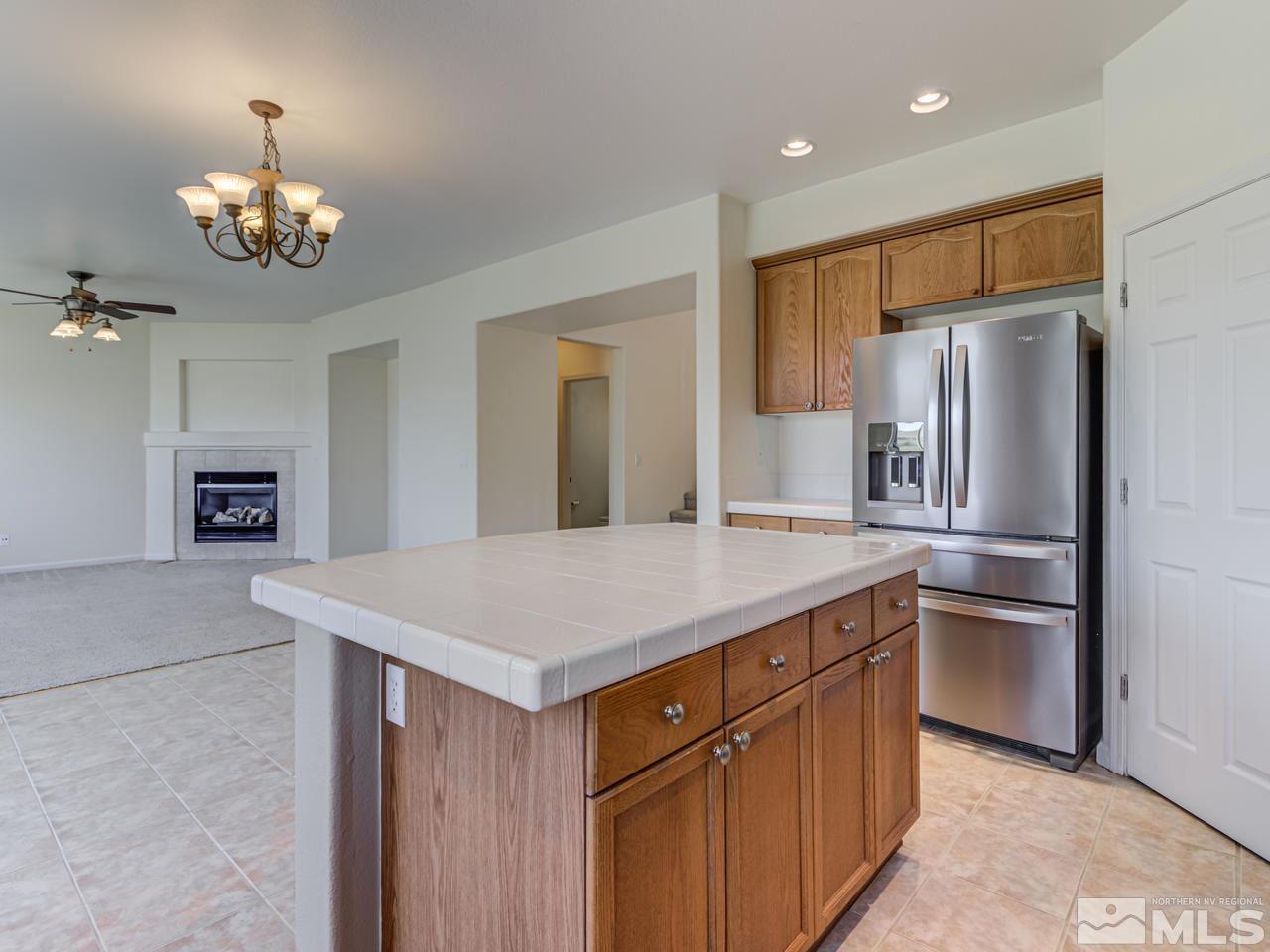 2525 Baton Drive Reno, NV 89521 - Photo 9 of 23 a kitchen with kitchen island a counter top space appliances and cabinets