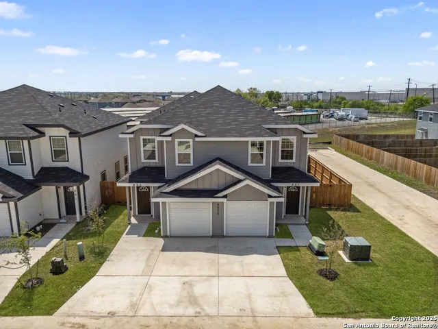 a view of multiple houses with a yard