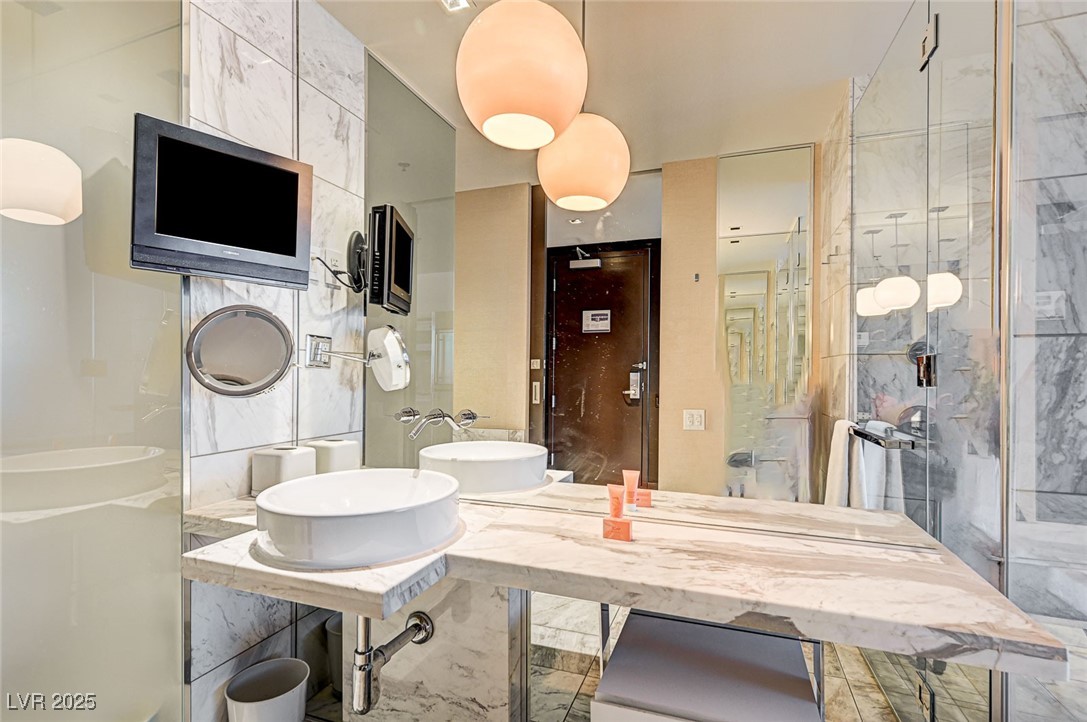 4381 West Flamingo Road, Unit 53307 Las Vegas, NV 89103 - Photo 17 of 45 Full bathroom with tile walls and a sink