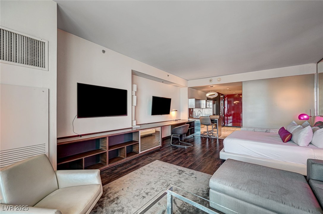 4381 West Flamingo Road, Unit 53307 Las Vegas, NV 89103 - Photo 8 of 45 Bedroom featuring dark wood-style floors and an office area