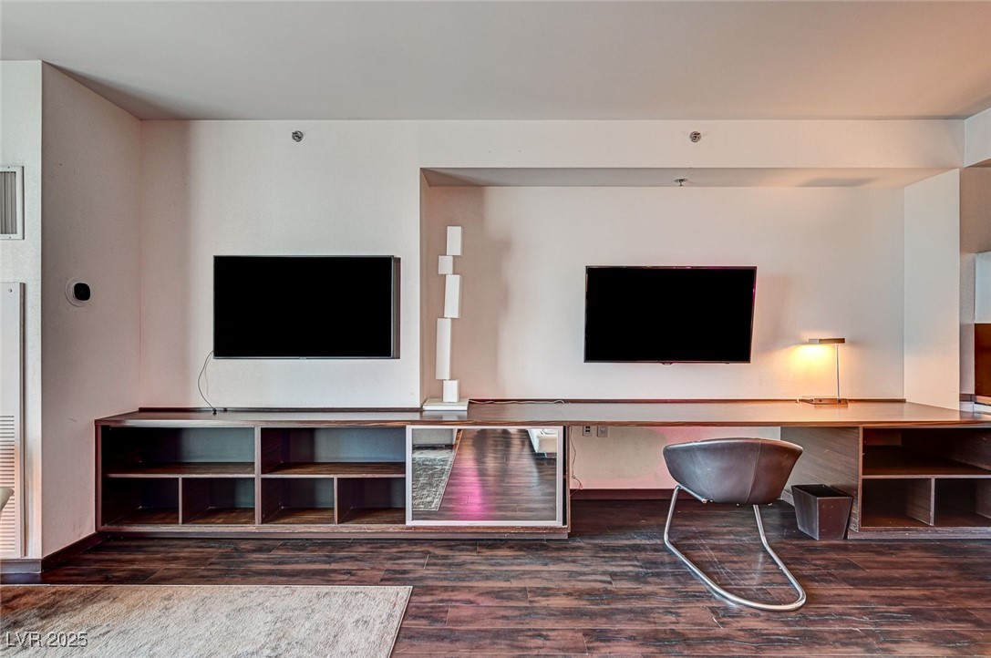 4381 West Flamingo Road, Unit 53307 Las Vegas, NV 89103 - Photo 9 of 45 Living area featuring dark wood-style flooring, a heating unit, and an office area
