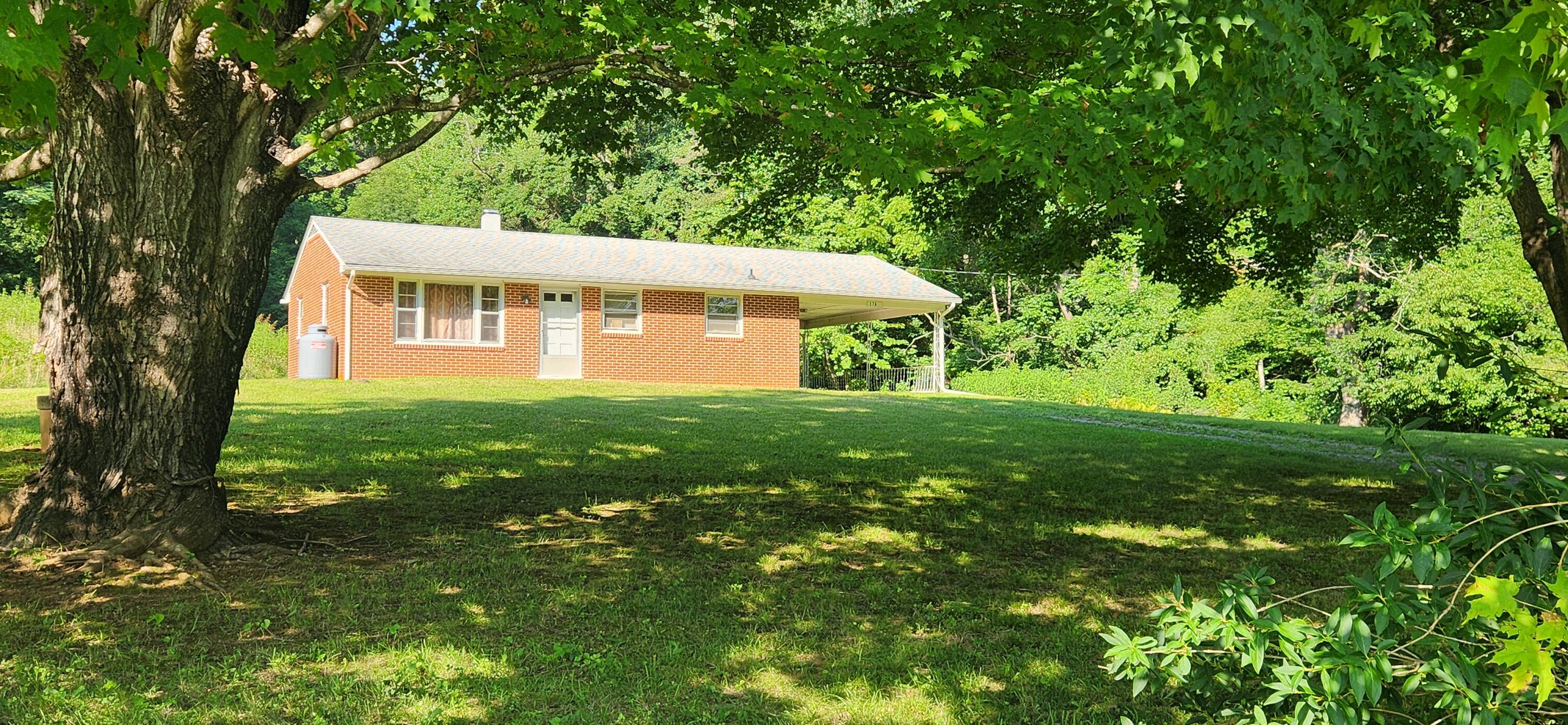 1762 Runnett Bag Road Ferrum, VA 24088 - Photo 2 of 14 a front view of a house with a yard