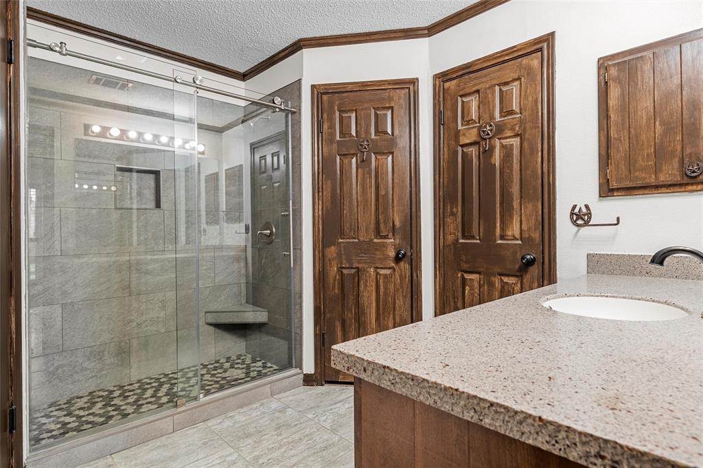 361 Vandiver Road Moody, TX 76557 - Photo 17 of 33 a bathroom with a granite countertop sink a mirror and shower