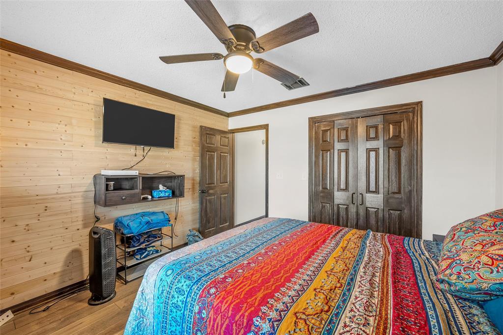361 Vandiver Road Moody, TX 76557 - Photo 24 of 33 a bedroom with a bed dresser and a flat tv screen
