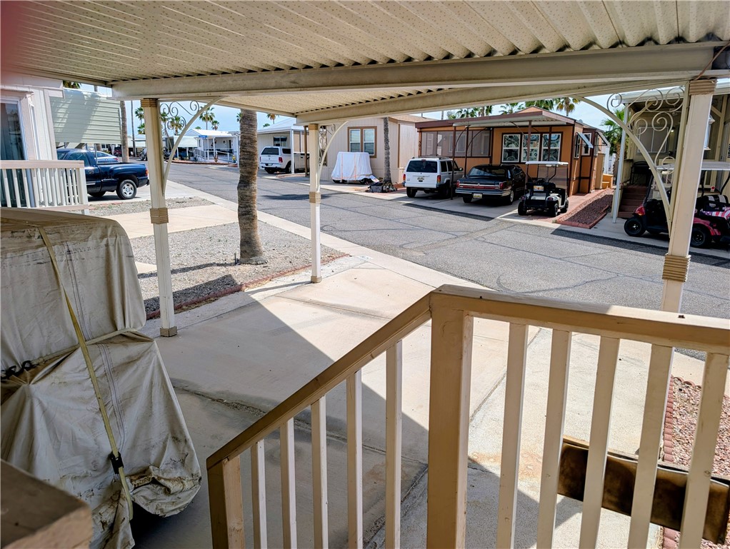 2000 Ramar Road, Unit 528 Bullhead City, AZ 86442 - Photo 6 of 30 The property features a covered patio area with a wooden railing, offering a shaded outdoor space