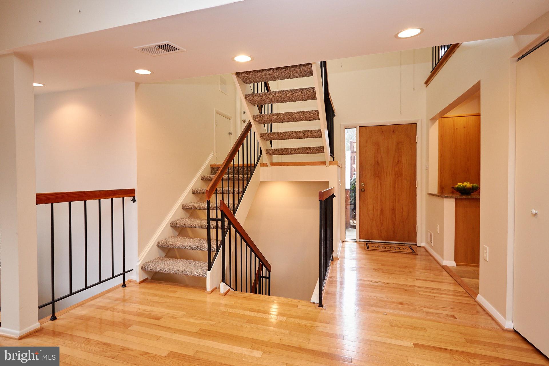 2113 Cabots Point Lane Reston, VA 20191 - Photo 12 of 56 a view of a hallway with wooden floor and staircase