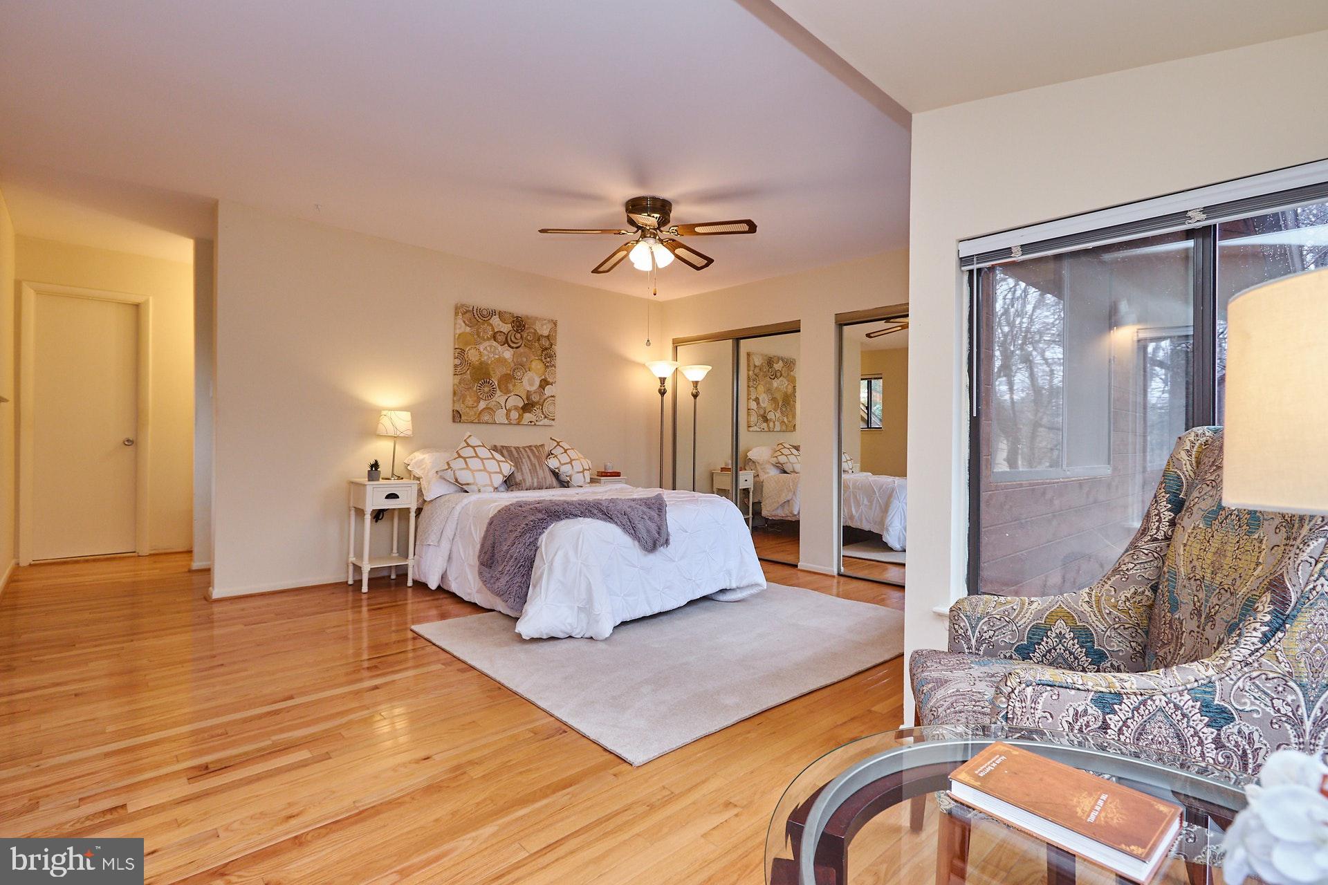 2113 Cabots Point Lane Reston, VA 20191 - Photo 13 of 56 a spacious bedroom with a bed and a chandelier