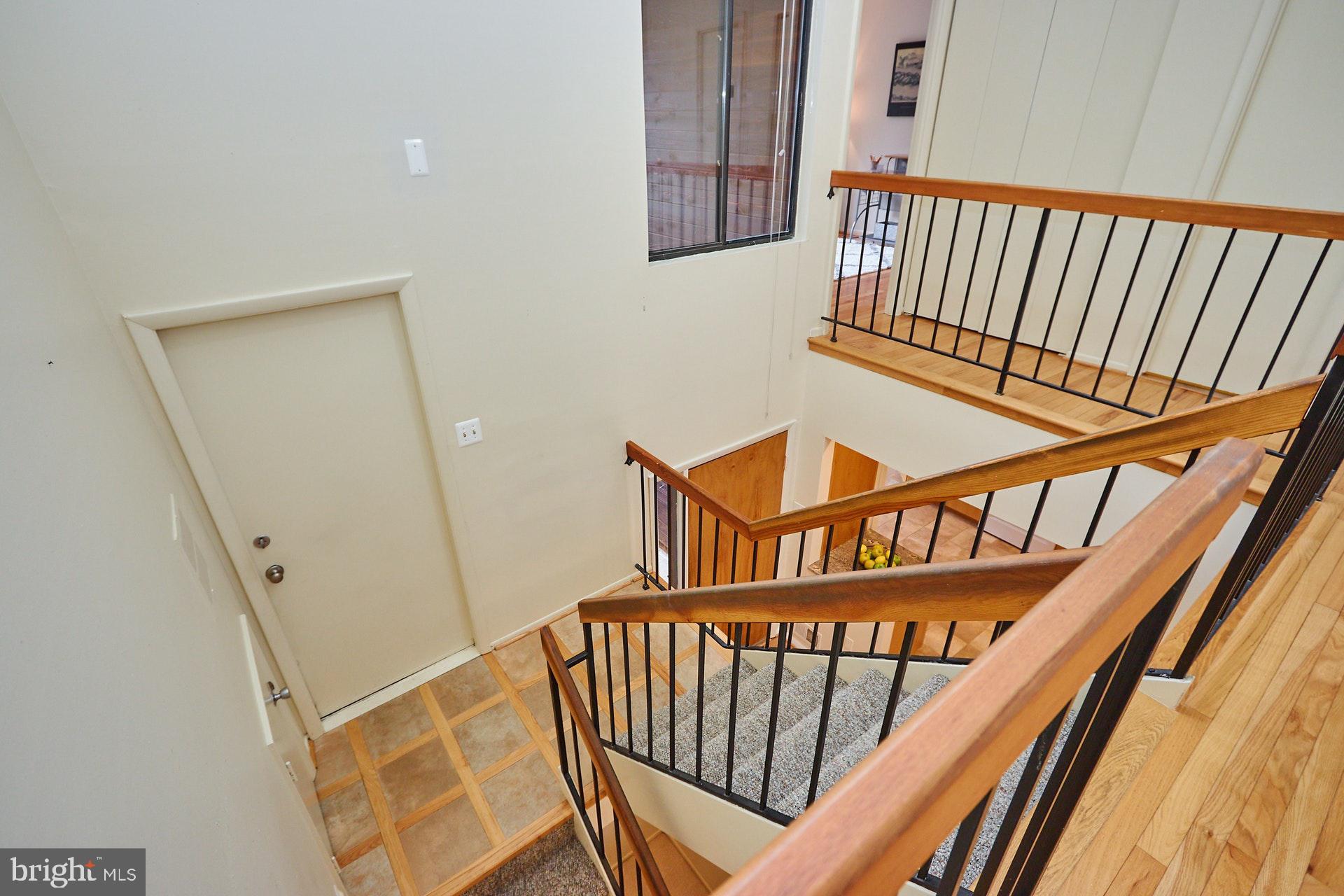 2113 Cabots Point Lane Reston, VA 20191 - Photo 49 of 56 a view of staircase with wooden floor and white walls