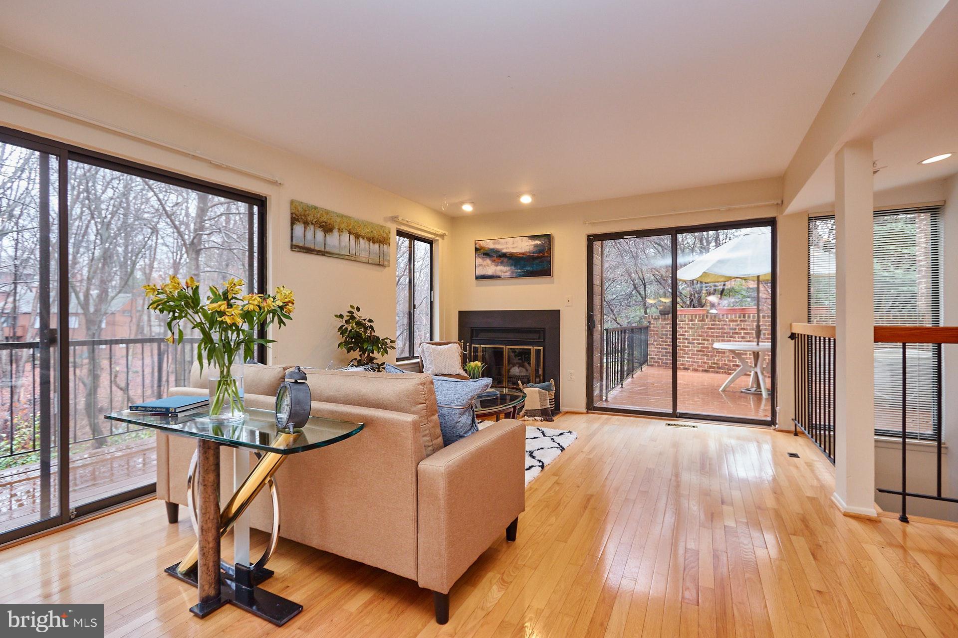 2113 Cabots Point Lane Reston, VA 20191 - Photo 6 of 56 a living room with furniture a large window and wooden floor