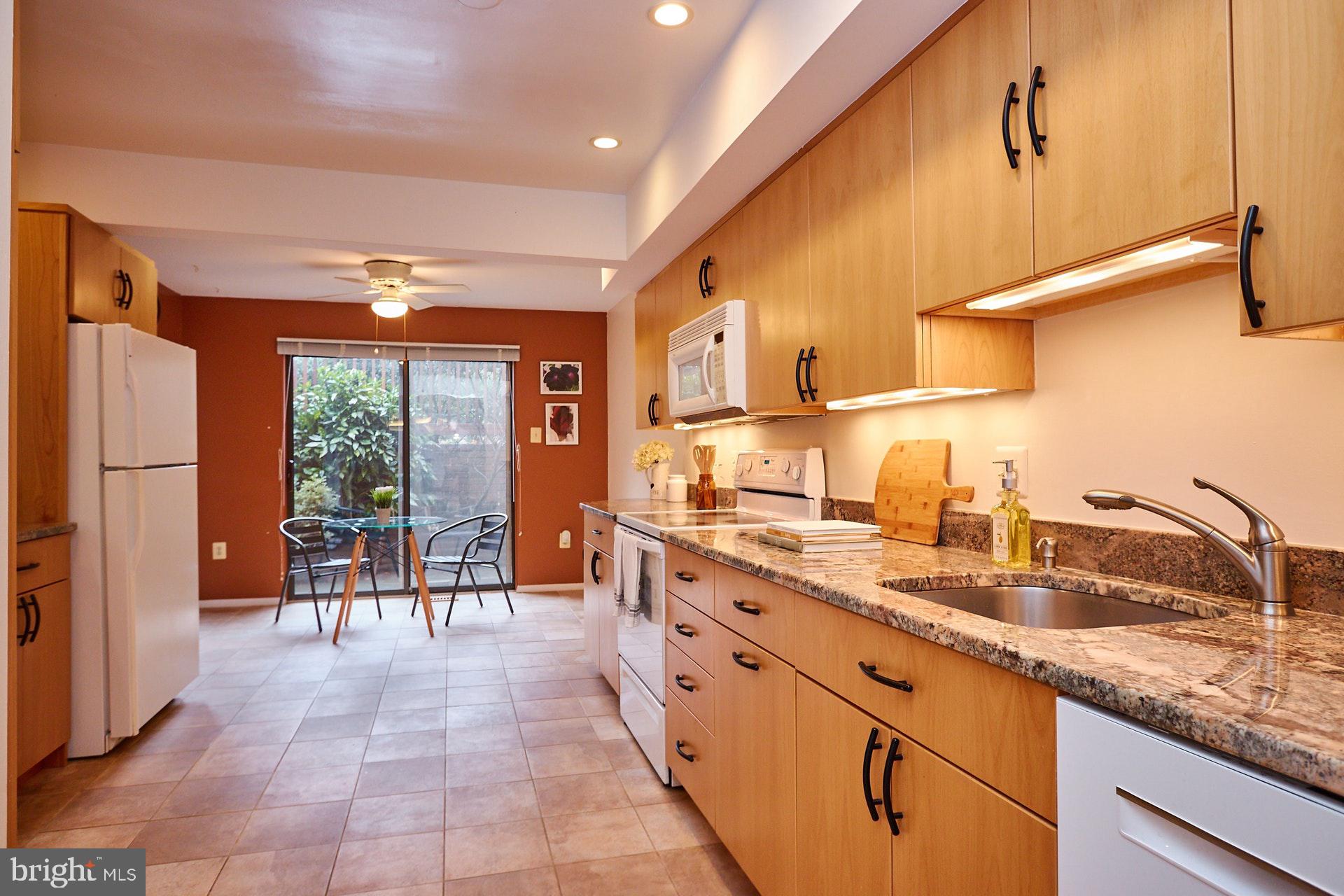 2113 Cabots Point Lane Reston, VA 20191 - Photo 7 of 56 a large kitchen with kitchen island a sink stainless steel appliances and cabinets