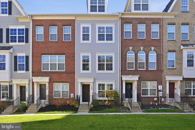 front view of a brick building with a yard