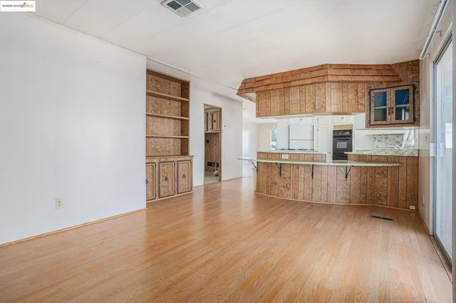 wooden floor in an empty room with a glass door