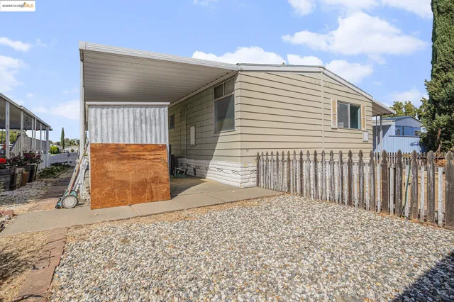 a view of a house with a wooden fence