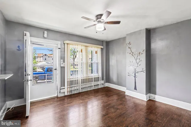 wooden floor in an empty room with a window