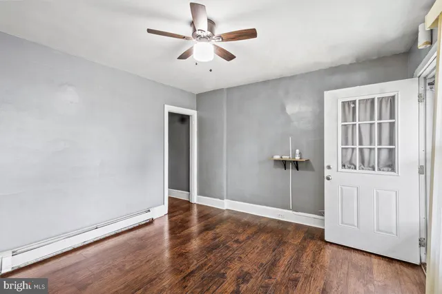 wooden floor in an empty room with a window