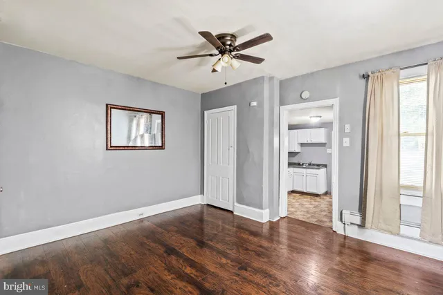 a view of a livingroom with a hardwood floor and a ceiling fan