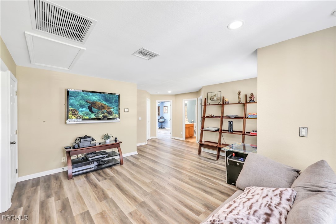 14067 Danpark Loop Fort Myers, FL 33912 - Photo 15 of 41 a bedroom with furniture and a wooden floor