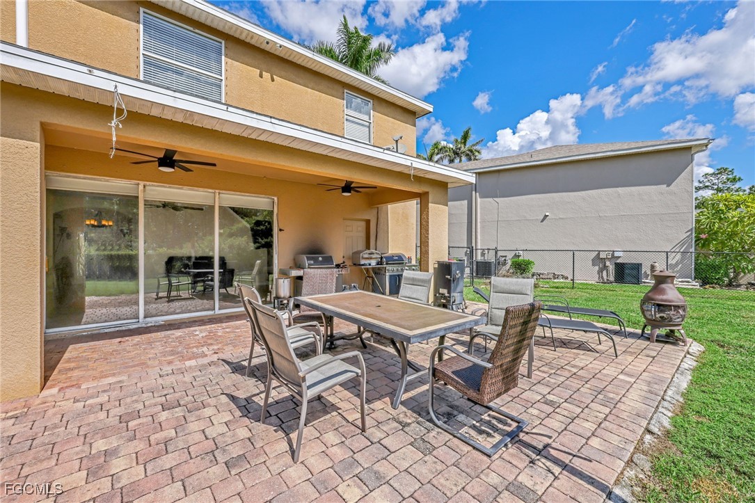 14067 Danpark Loop Fort Myers, FL 33912 - Photo 28 of 41 a view of a patio with a table and chairs and potted plants