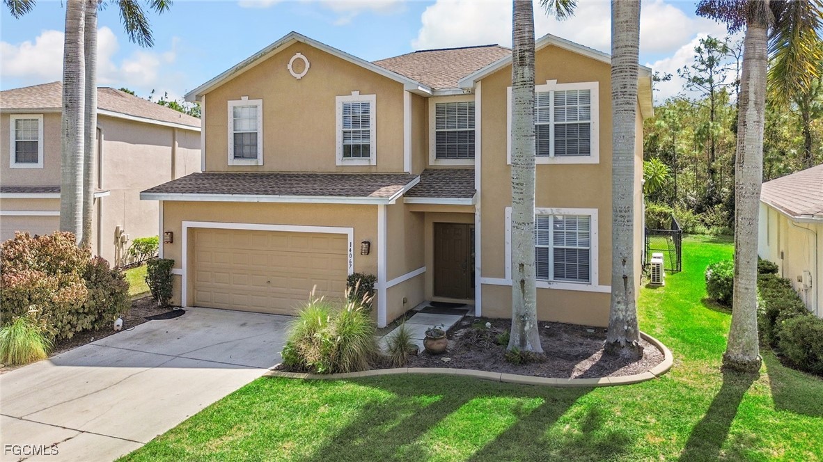 14067 Danpark Loop Fort Myers, FL 33912 - Photo 3 of 41 a front view of a house with a yard and garage