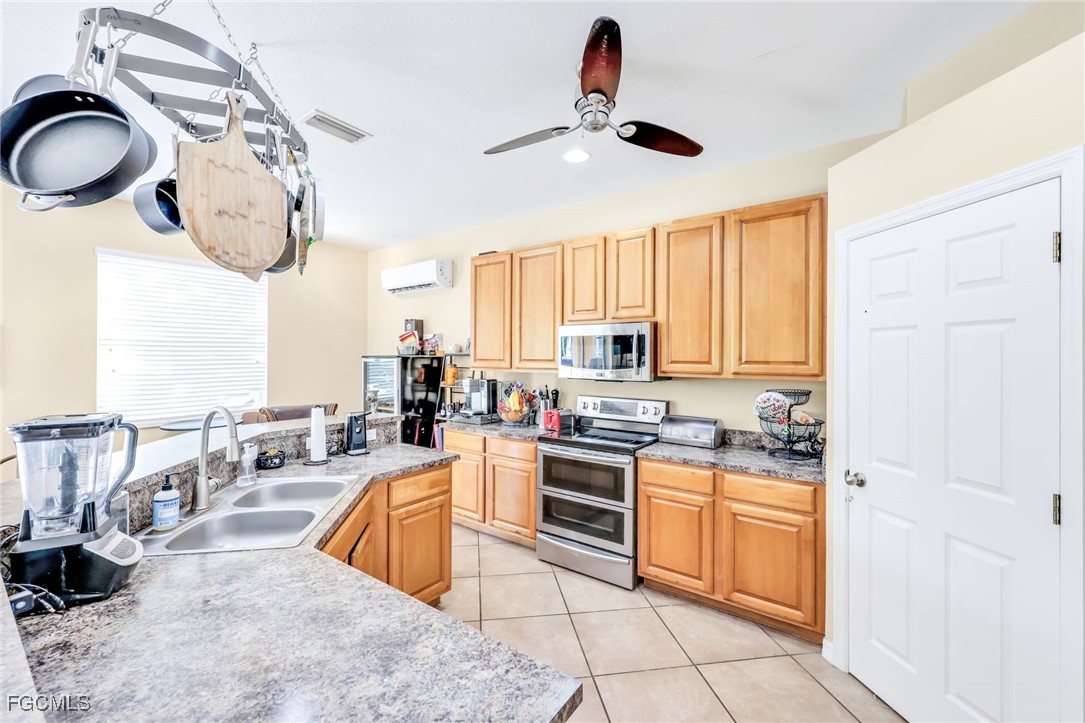 14067 Danpark Loop Fort Myers, FL 33912 - Photo 8 of 41 a kitchen with stainless steel appliances granite countertop a stove a sink and a refrigerator
