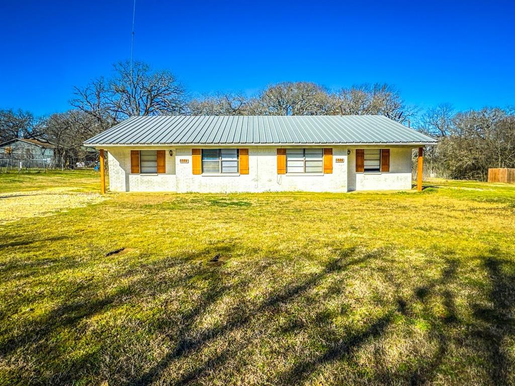 617 County Road 805A, Unit 1 Cleburne, TX 76031 - Photo 1 of 1 a front view of a house with a yard
