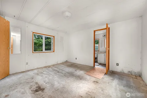 an empty room with windows and closet