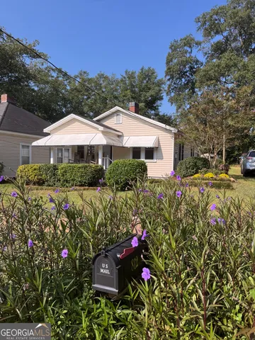 a view of a house with a yard and garden